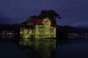 une maison sur l'eau la nuit fading aux arts